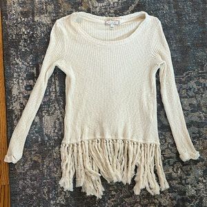 Adorable cream colored sweater, open slit in back with tassels.